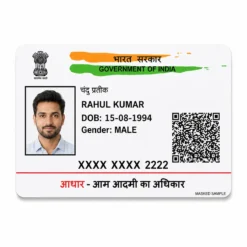 Masked Aadhaar PVC card front view with fictional Indian details and visible date of birth